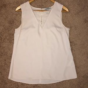 Cream sleeveless blouse with lace neckline